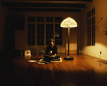 Steve Jobs Sitting in an Almost Unfurnished Room Only Lit by a Tiffany Lamp Having a Cup of Tea